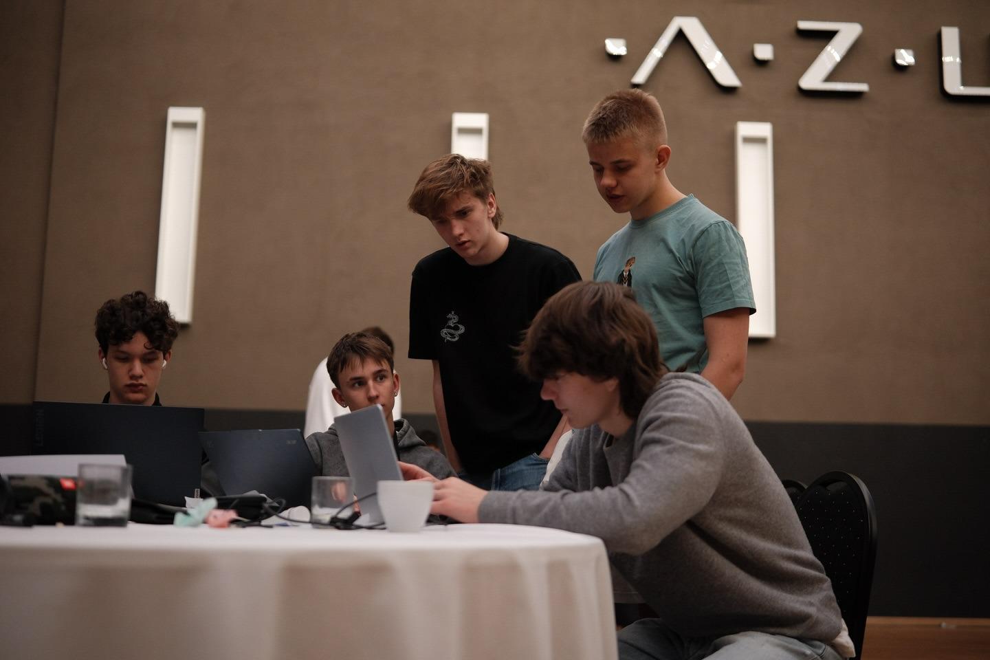 Four team members at the venue working at their laptops